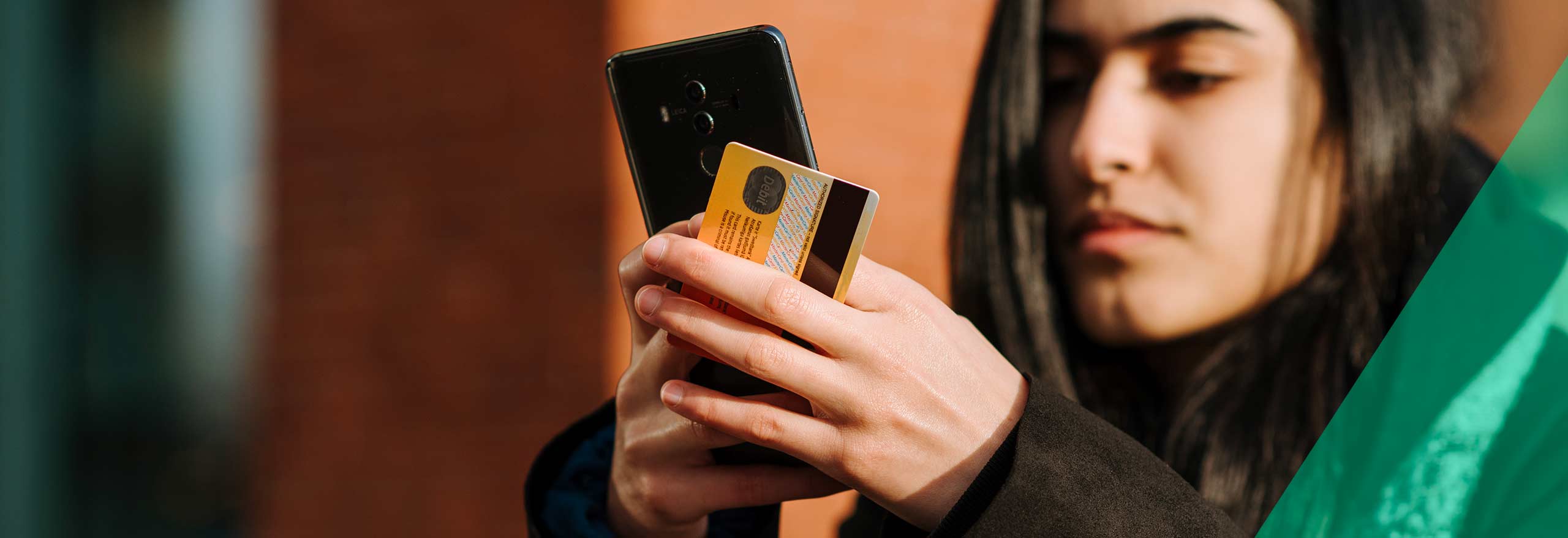 Une femme paie un article avec sa carte de crédit sur son téléphone 